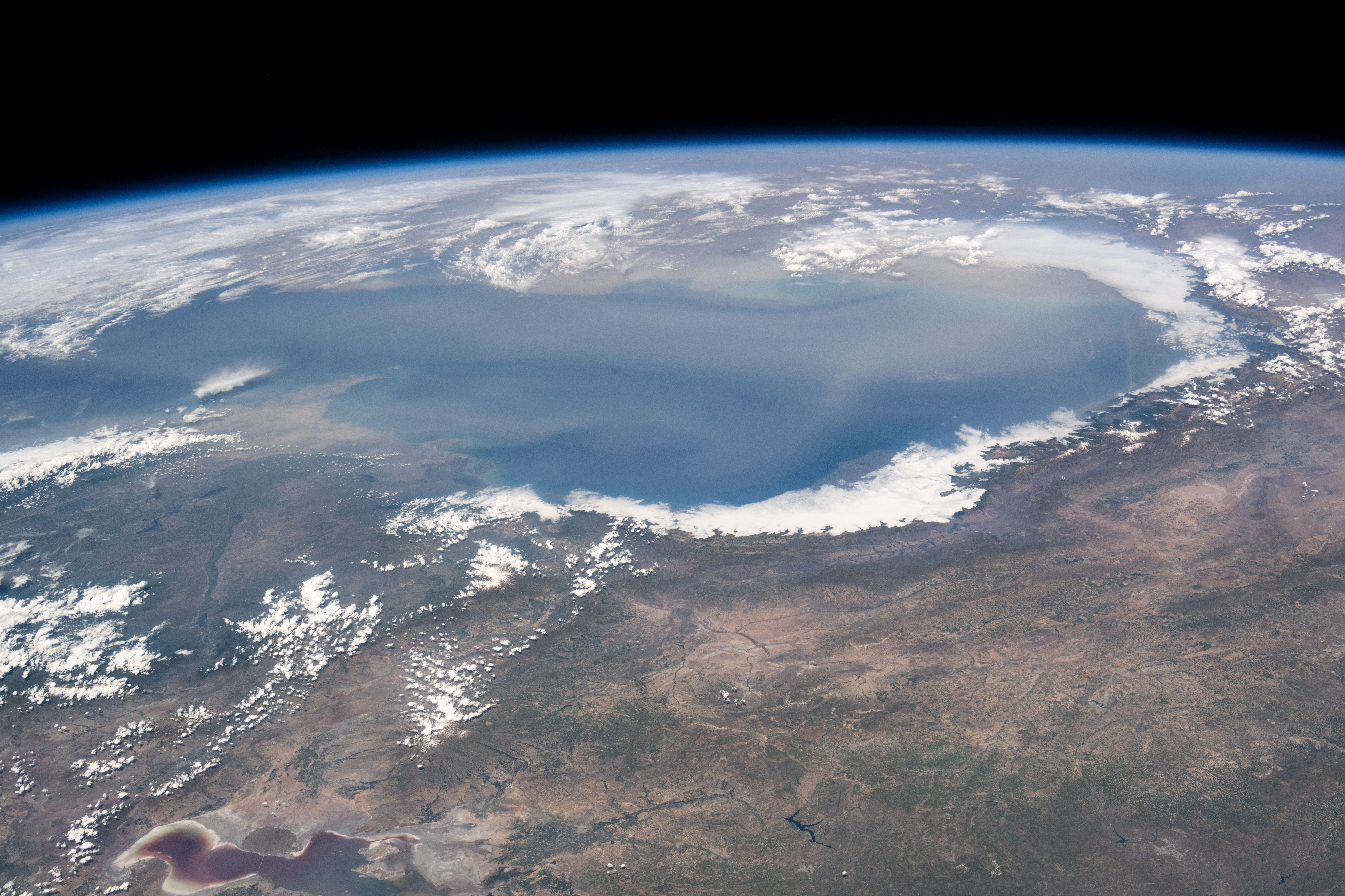 The world's largest inland body of water, the Caspian Sea rests in between Europe and Asia and is bordered by the nations of Russia, Kazakhstan, Turkmenistan, Iran, and Azerbaijan. The International Space Station was orbiting 262 miles above Erbil, Iraq, at the time of this photograph.