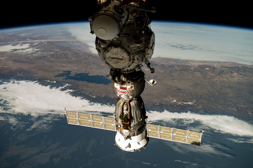 The Soyuz MS-25 crew ship is pictured docked to the Prichal docking module as the International Space Station orbited 258 miles above South America. Highlights in the background of this photograph include Lake Titicaca and the snow-capped Andes mountiain range.