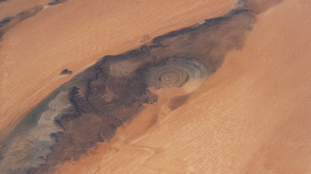The Rihat Structure, also known as the Eye of the Sahara, is a deeply eroded geologic dome in the African nation of Mauritania pictured from the International Space Station as it orbited 258 miles above.
