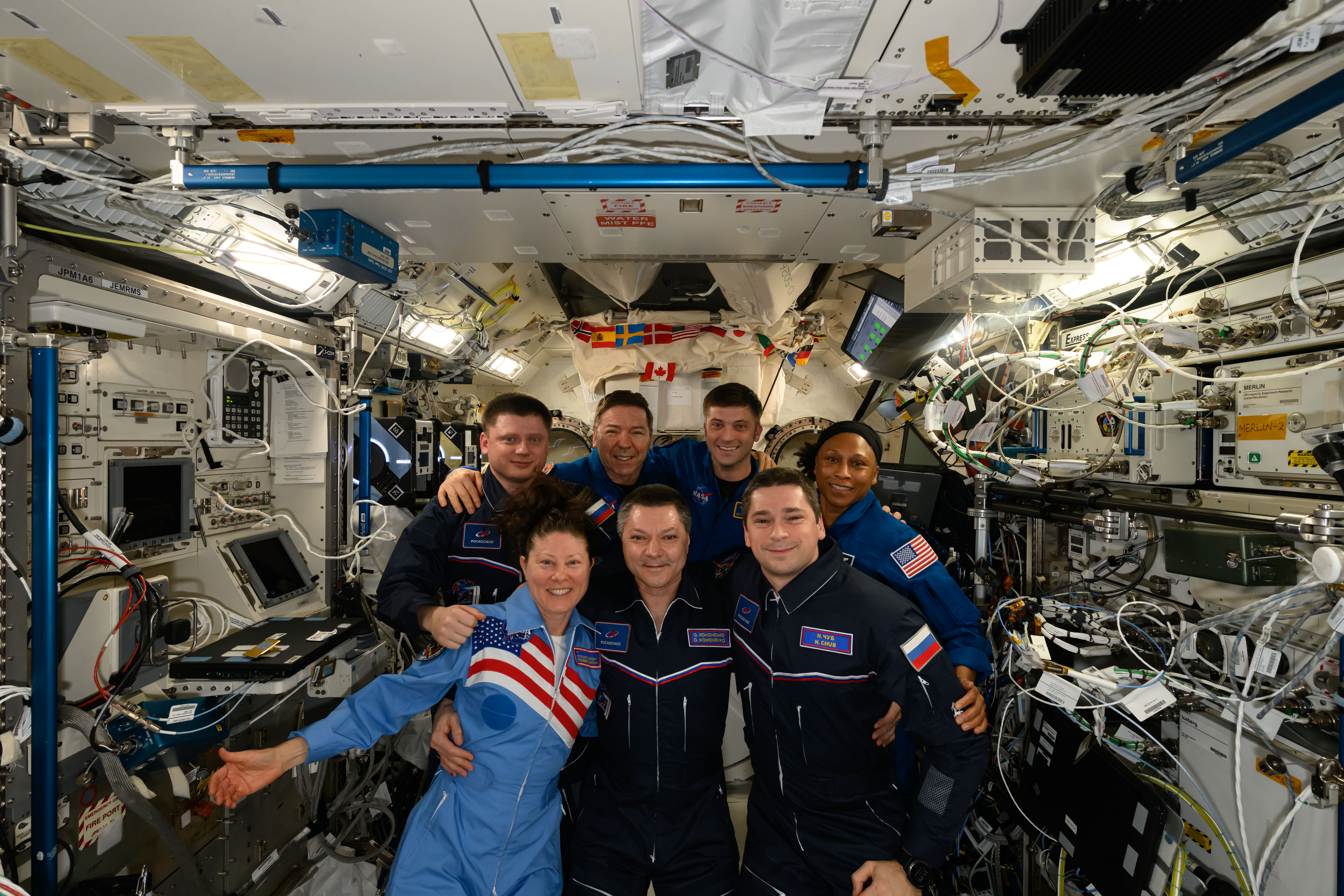 The seven Expedition 71 crew members gather with the two Crew Flight Test members for a team portrait aboard the space station. In the front from left are, Suni Williams, Oleg Kononenko, and Butch Wilmore. Second row from left are, Alexander Grebenkin, Tracy C. Dyson, and Mike Barratt. In the back are, Nikolai Chub, Jeanette Epps, and Matthew Dominick.