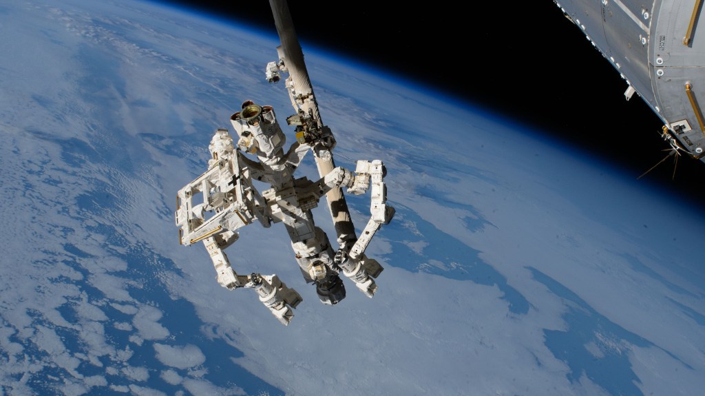 Dextre, the fine-tuned robotic hand attached to the Canadarm2 robotic arm, extends from the International Space Station while orbiting 259 miles above the Pacific Ocean southwest of Baja California.