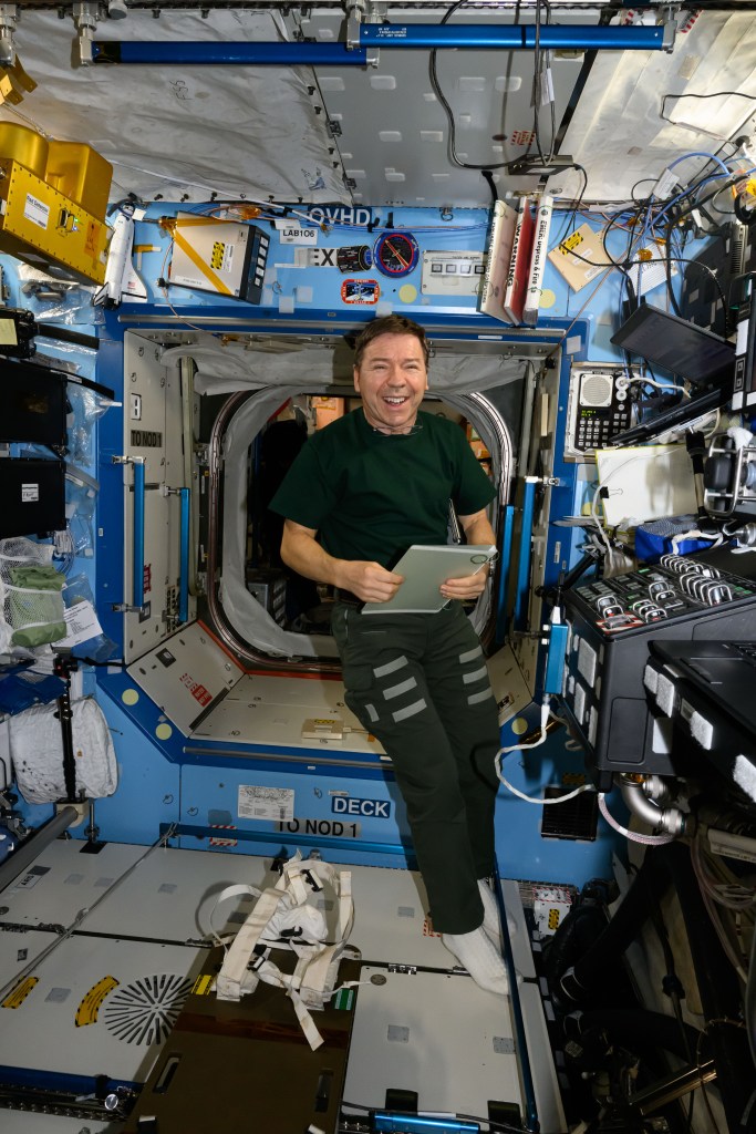 NASA astronaut and Expedition 71 Flight Engineer Mike Barratt smiles for portrait inside the International Space Station's Destiny laboratory module.