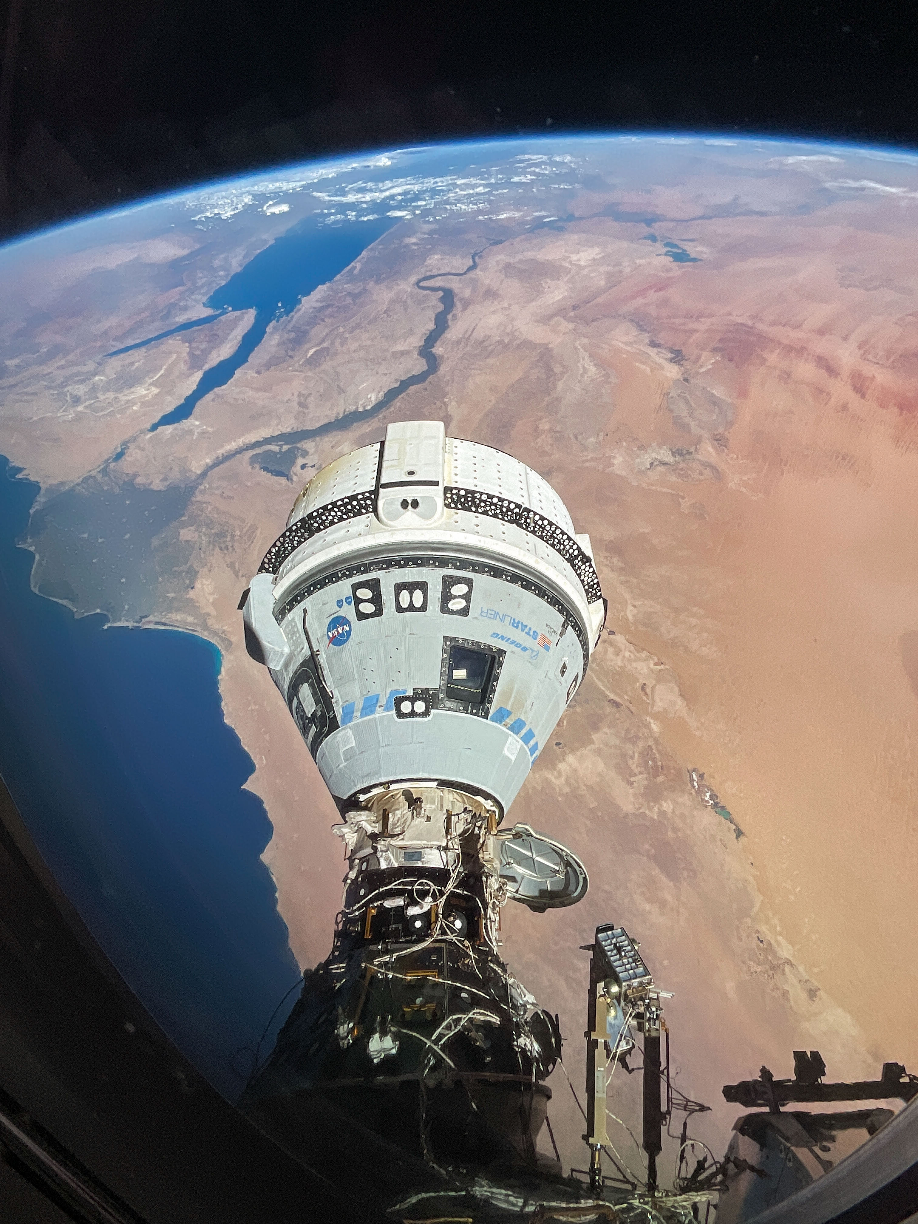 The Starliner spacecraft on NASA's Boeing Crew Flight Test is pictured docked to the Harmony module's forward port as the International Space Station orbited 262 miles above Egypt's Mediterranean coast.