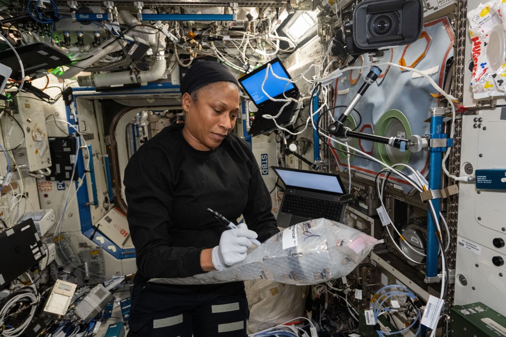NASA astronaut and Expedition 71 Flight Engineer Jeanette Epps documents research hardware while working in the International Space Station's Destiny laboratory module.