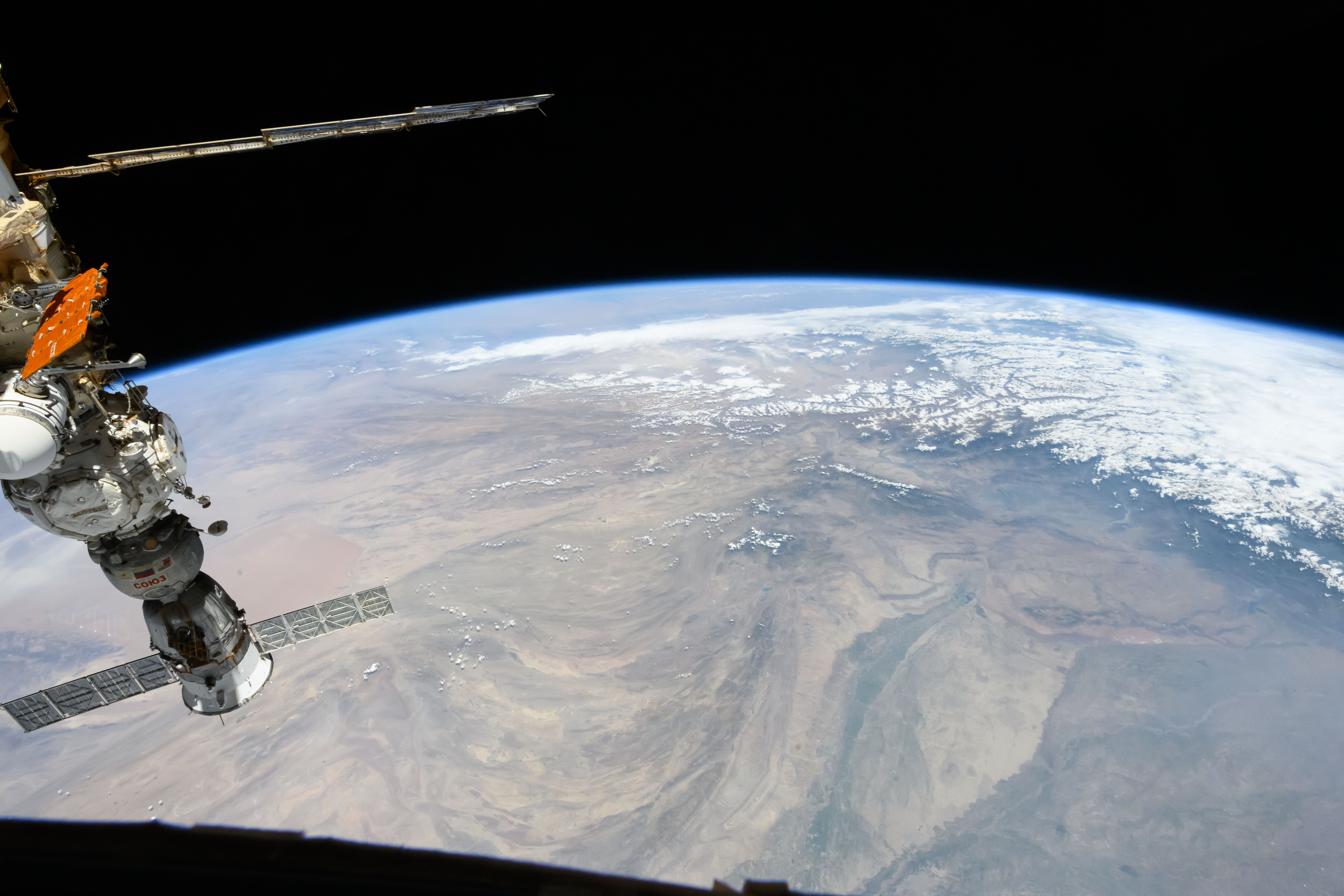 The snow-covered Himalayas separate the Indian sub-continent from China in this photograph from the International Space Station as it orbited 264 miles above. At left, is the Soyuz MS-25 crew ship docked to the Prichal docking module.