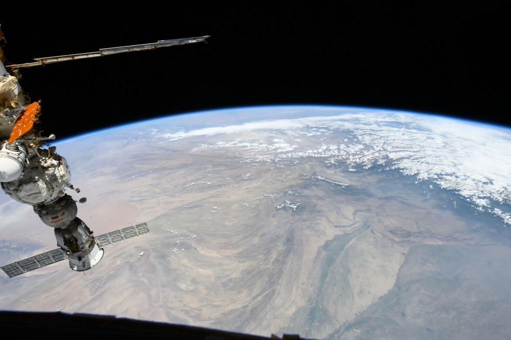 The snow-covered Himalayas separate the Indian sub-continent from China in this photograph from the International Space Station as it orbited 264 miles above. At left, is the Soyuz MS-25 crew ship docked to the Prichal docking module.