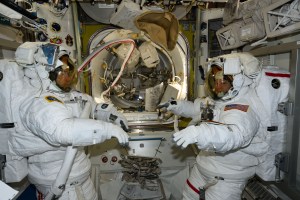 NASA astronauts (from left) Mike Barratt and Tracy C. Dyson, both Expedition 71 Flight Engineers, are pictured in the Quest airlock prior to the start of a science and maintenance spacewalk that ended early after Dyson's suit experienced a water leak in the service and cooling umbilical unit.