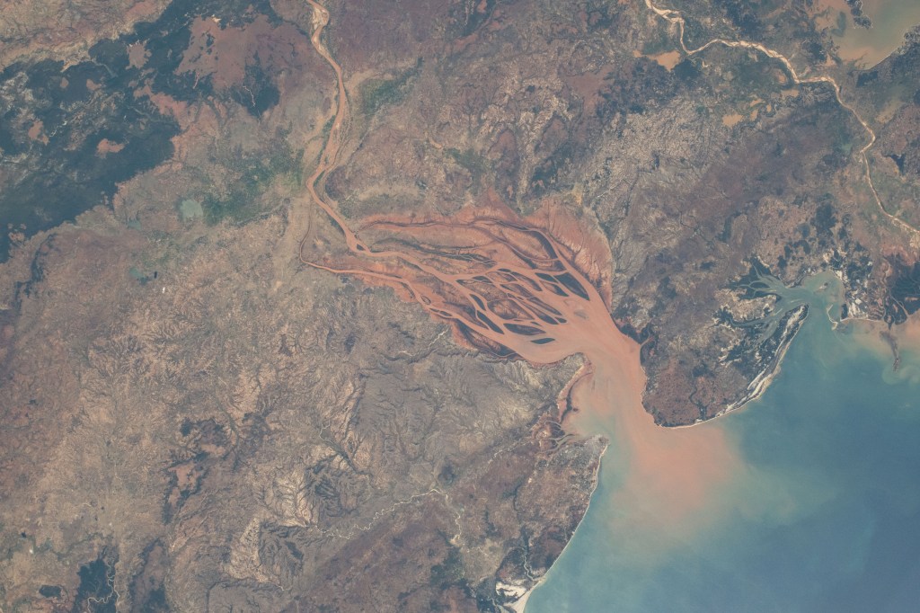 iss071e218069 (June 26, 2024) -- On Madagascar's northwestern coast, the Mozambique Channel flows inland to the Betsiboka River, forming Bombetoka Bay. The reddish-brown color is the result of iron-rich sediment transporting through, creating a striking visual marker for astronauts aboard the International Space Station. This photograph was taken as the orbiting laboratory soared 266 miles above Earth.