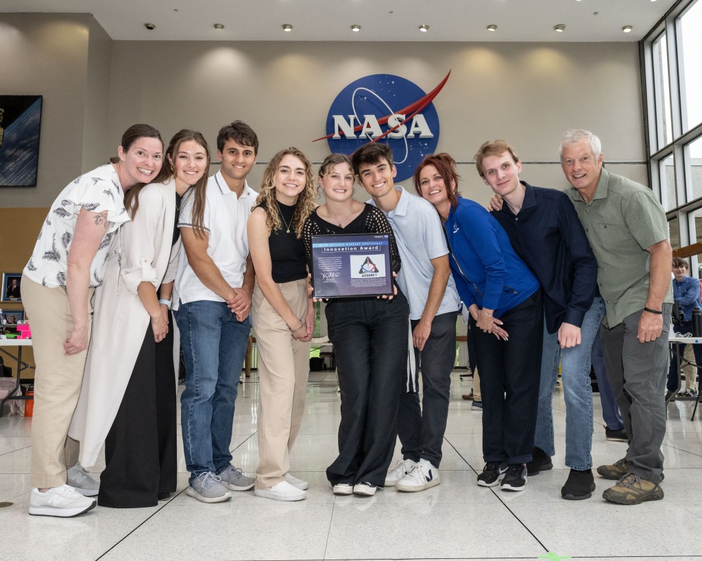 A student team from Boise State University poses with an Innovation Award they received at Micro-g NExT at Johnson Space center.