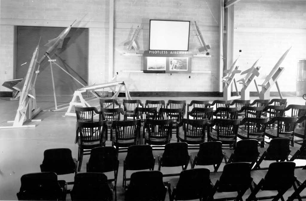 Empty chairs in front of exhibit.