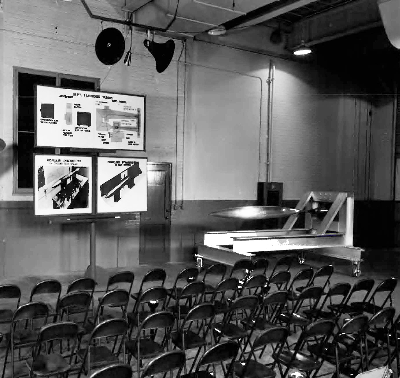 Empty chairs in front of exhibit