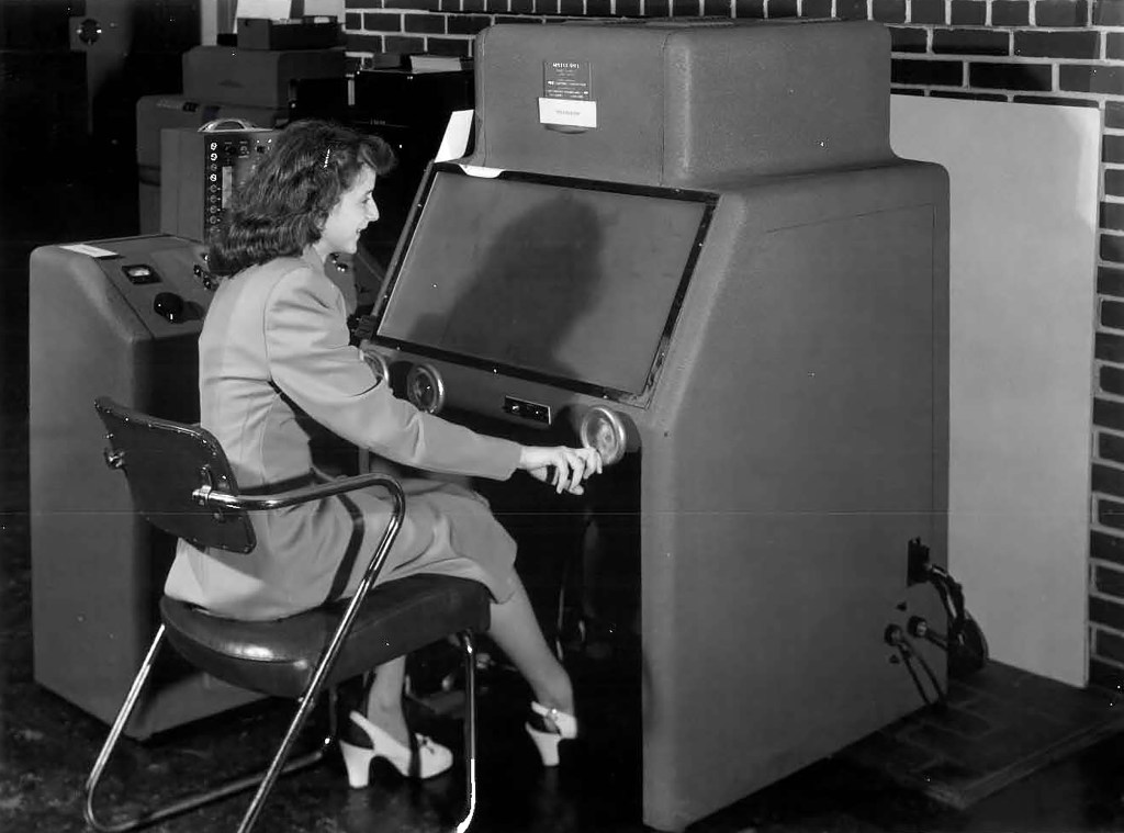 Woman seated at computer.