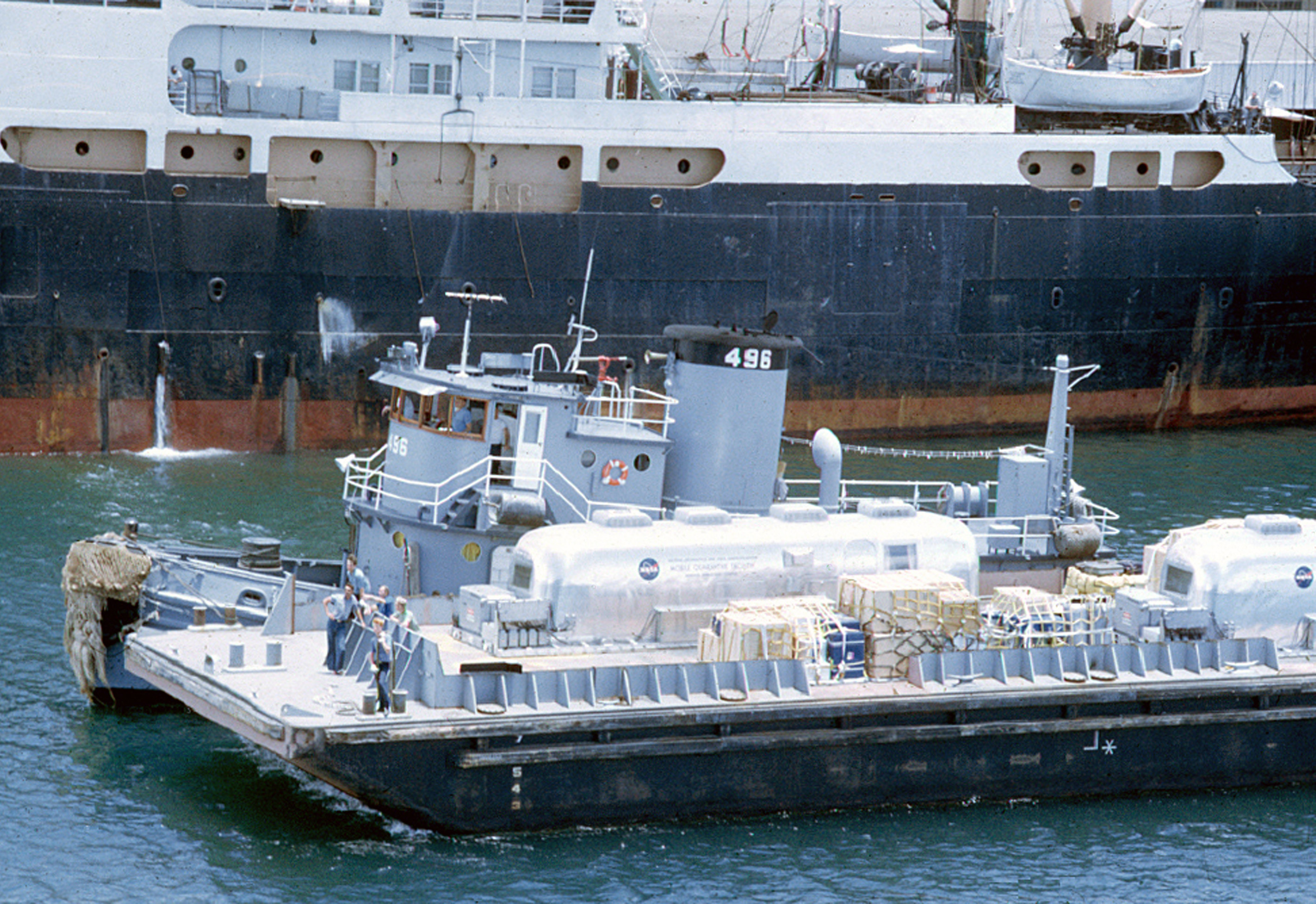 In Pearl Harbor, Hawaii, workers barge the prime and backup MQFs to load them onto the U.S.S. Hornet