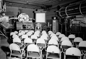 Empty chairs in front of exhibit.