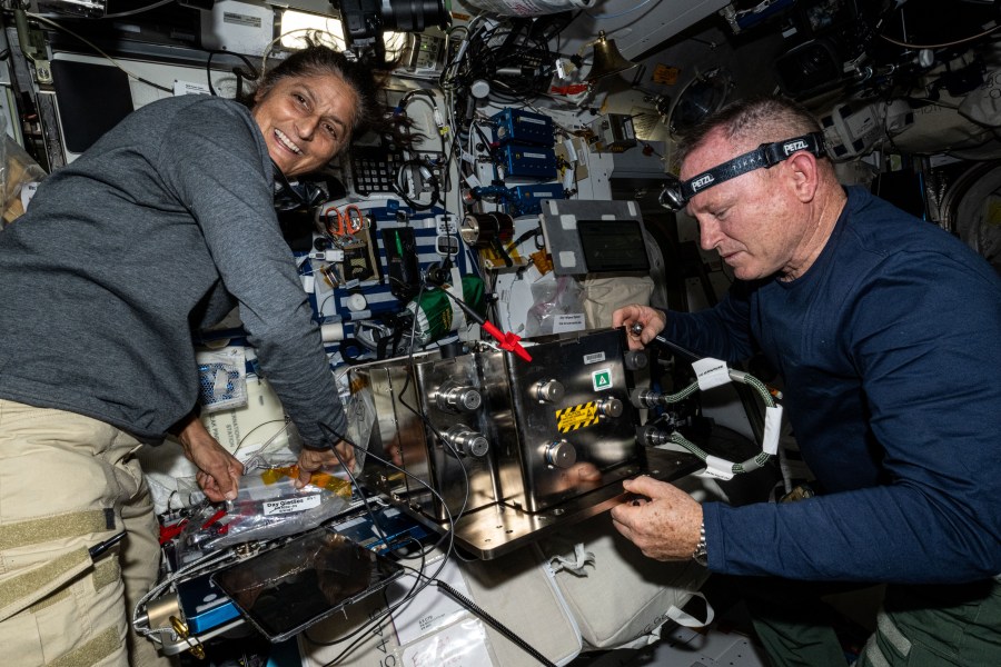 NASA's Boeing Crew Flight Test astronauts Suni Williams and Butch Wilmore prepare orbital plumbing hardware for installation inside the International Space Stationâs bathroom