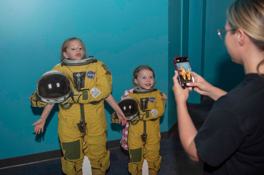 Two young visitors to the Audubon Aquarium in New Orleans pose as NASA astronauts
