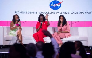 A 3-member panelists of women sit on a white sofa to lead a discussion on becoming a shining star; The NASA meatball can be seen on the screen in the background