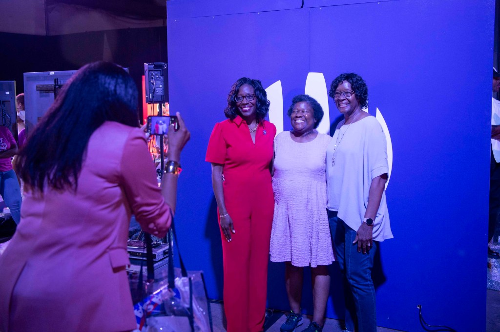 Lakiesha Hawkins, left, takes a picture with attendees of the 30th annual ESSENCE Fest