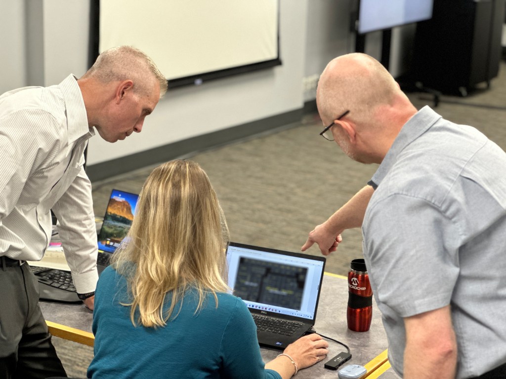 Microchip engineers reviewing the High Performance Spaceflight Computer (HPSC) floor plan, a crucial step in the design process that ensures the Microprocessor Unit (MPU) will meet the stringent requirements for future NASA missions, providing the necessary advances in performance, fault tolerance, and flexibility.