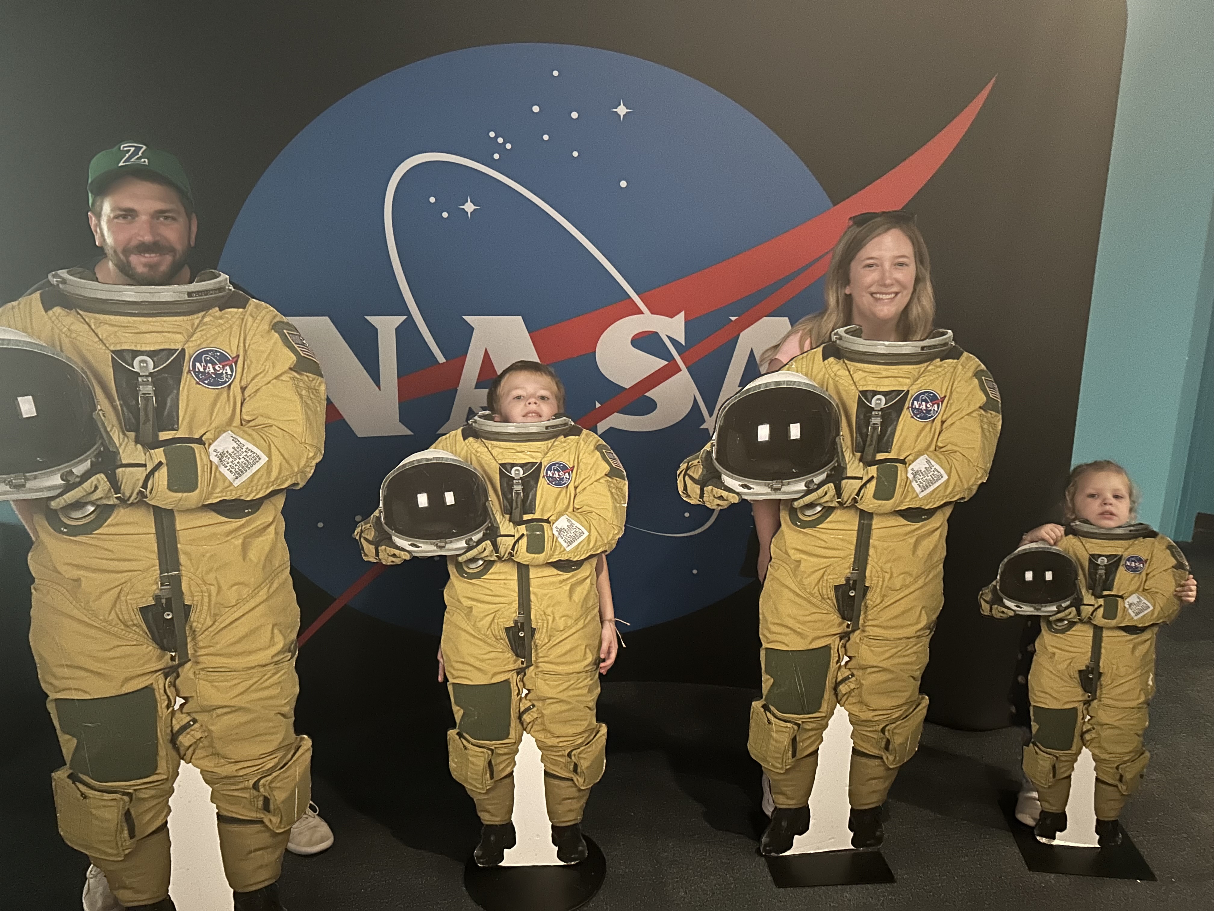 A family of four pose with the astronaut display at the Audubon Aquarium