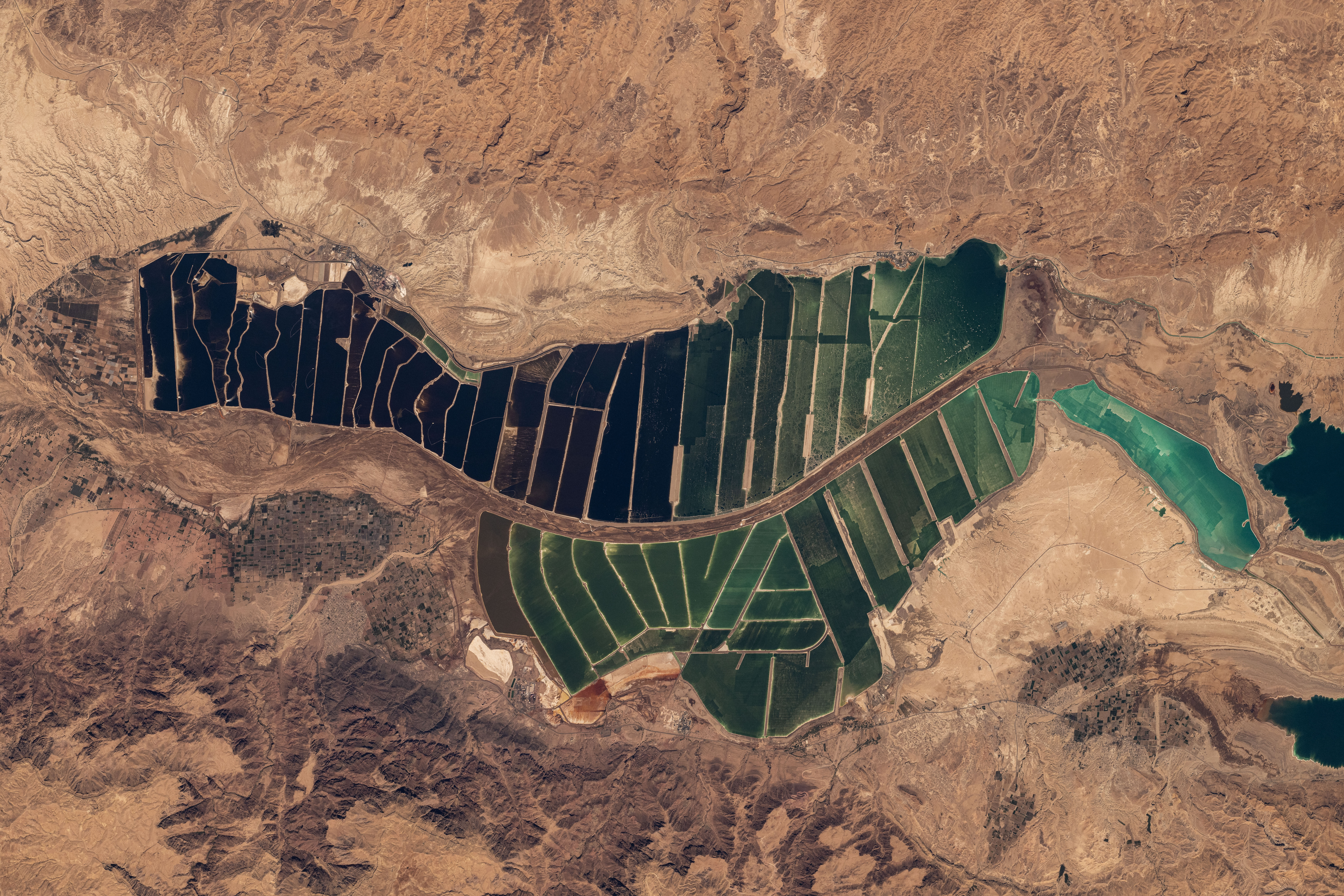 Salt evaporation ponds south of the Dead Sea in between Israel and Jordan are pictured from the International Space Station as it orbited 263 miles above the Middle East.