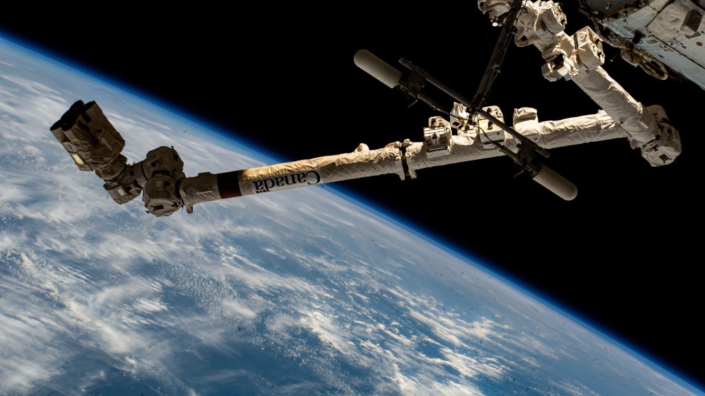 The 57.7-foot-long Canadarm2 robotic arm extends outward from the International Space Station as it orbited 264 miles above the Indian Ocean off the coast of the African nation of Somalia.