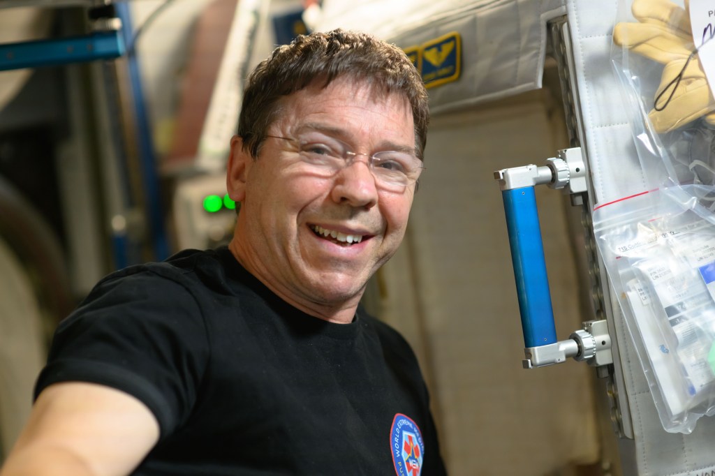 NASA astronaut and Expedition 71 Flight Engineer Mike Barratt smiles for a portrait aboard the International Space Station.