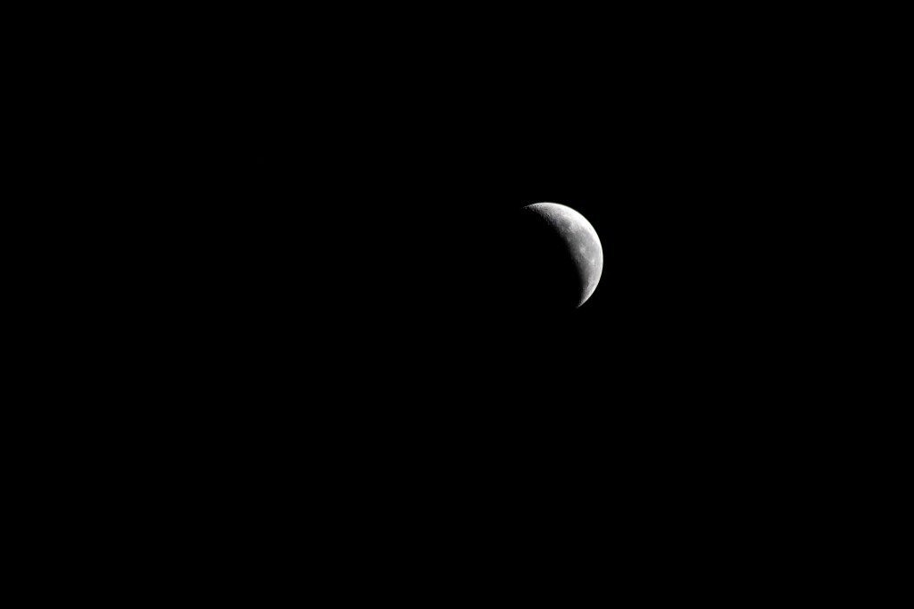 iss071e256627 (June 30, 2024) -- A waning crescent moon hangs against the black of space as the International Space Station orbited 258 miles above Italy.