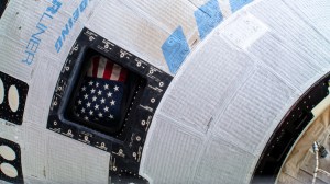 The American flag is pictured inside the window of the Boeing Starliner spacecraft that carried NASA astronauts Butch Wilmore and Suni Williams to the International Space Station on NASA's Boeing Crew Flight Test.