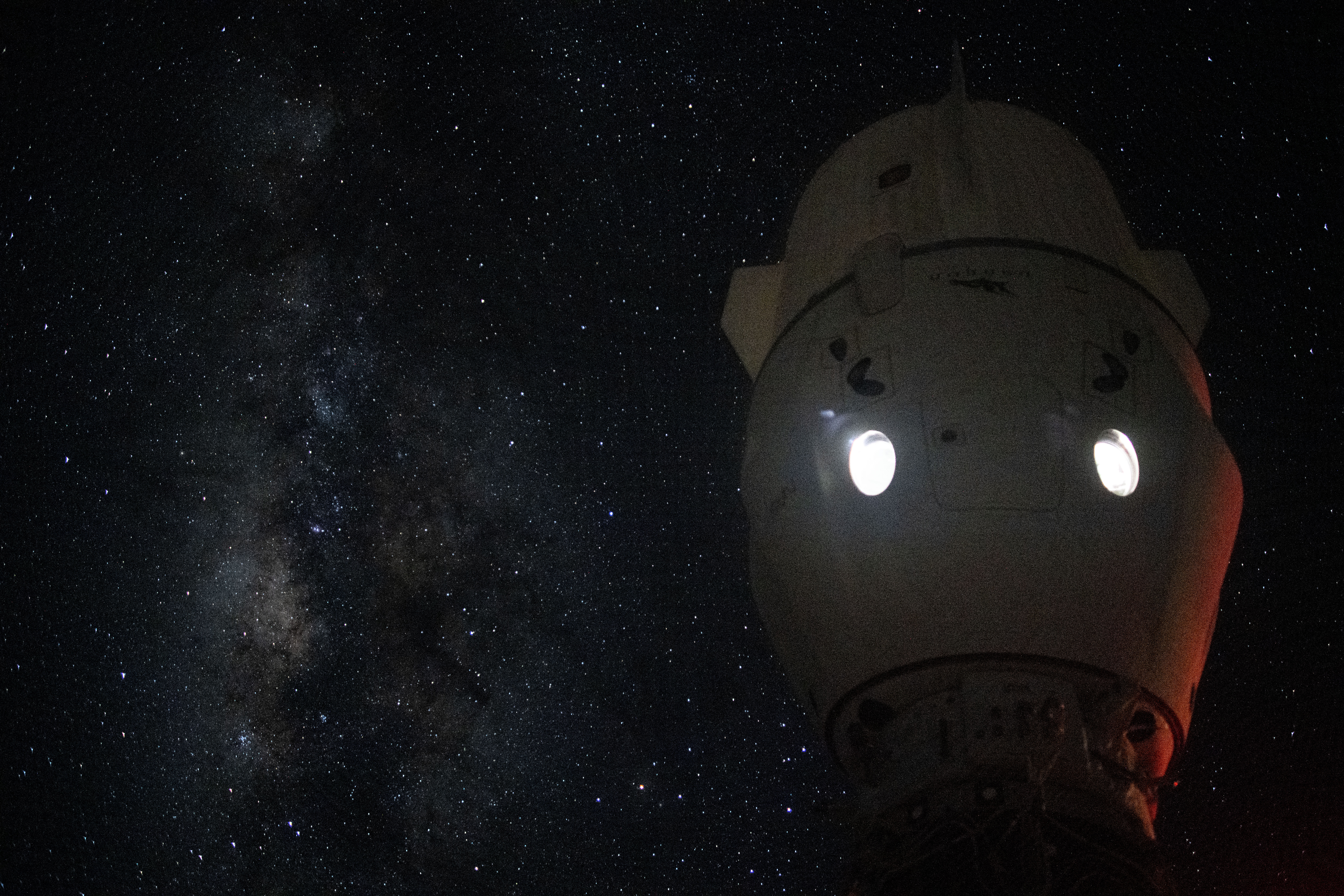 The Milky Way appears in the vastness of space behind the SpaceX Dragon Endeavour spacecraft docked to the Harmony module's space-facing port on the International Space Station.