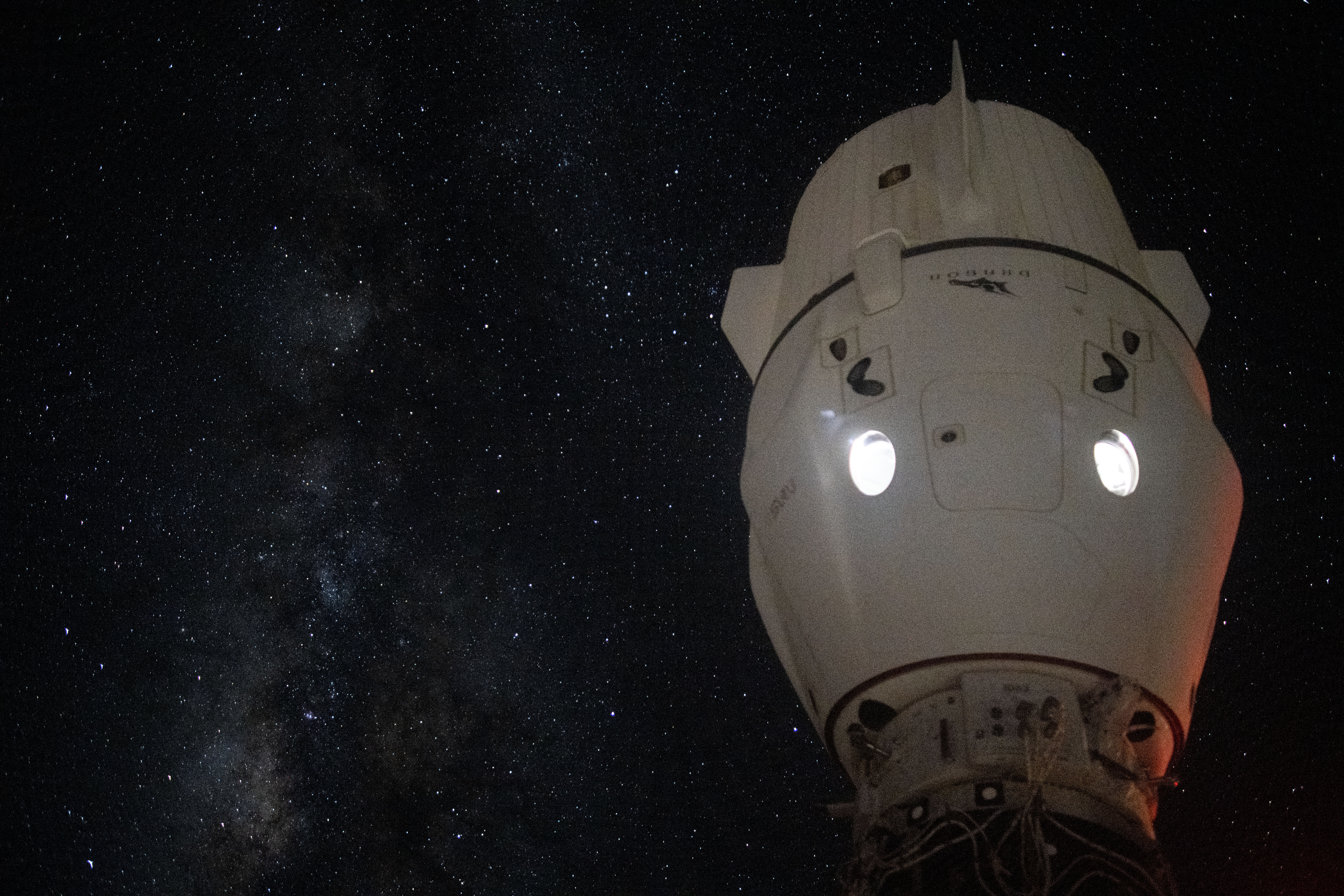 The Milky Way appears in the vastness of space behind the SpaceX Dragon Endeavour spacecraft docked to the Harmony module's space-facing port on the International Space Station.