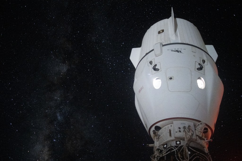 The Milky Way appears in the vastness of space behind the SpaceX Dragon Endeavour spacecraft docked to the Harmony module's space-facing port on the International Space Station.