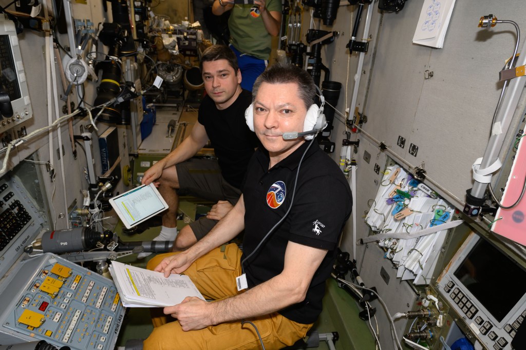 Expedition 71 Commander Oleg Kononenko (foreground) and Flight Engineer Nikolai Chub, both Roscosmos cosmonauts, are pictured inside the International Space Station's Zvezda service module monitoring the automated rendevous and docking of the Progress 88 cargo craft to the Poisk module. The duo was at the controls of Zvezda's TORU, or telerobotically-operated rendezvous unit, ready to take remote control of the Progress 88, packed with about three tons of food, fuel, and supplies for the Expedition 71 crew, in the unlikely event the spacecraft would be unable to dock on its own.