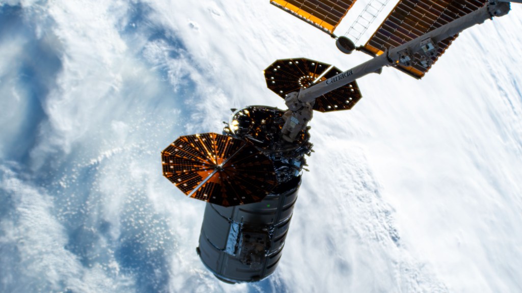 Northrop Grumman's Cygnus space freighter is attached to the leading end effector of the 57.7-foot-long Canadarm2 robotic arm about to be released into Earth orbit ending a five-and-a-half month cargo mission berthed to the International Space Station's Unity module.