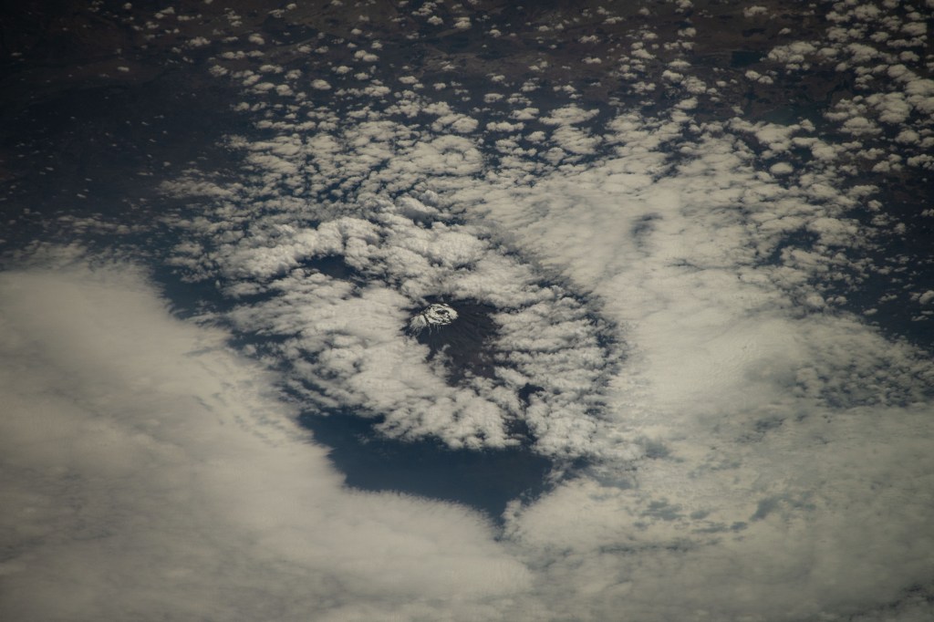 Mount Kilimanjaro, surrounded by clouds and the highest mountian in Africa, is pictured from the International Space Station as it orbited 261 miles above the Indian Ocean off the coast of Tanzania.