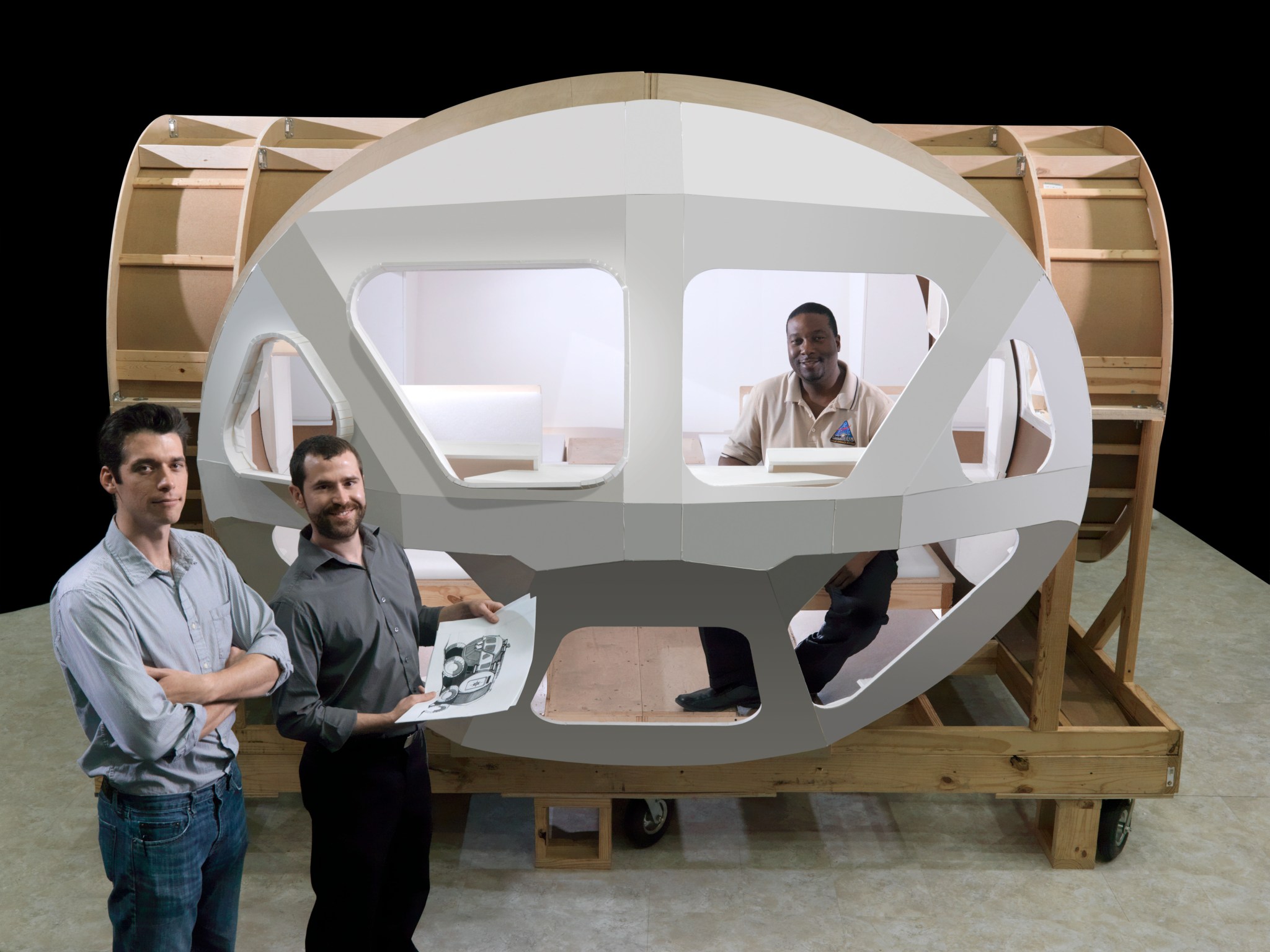 Three male NASA engineers perform a window node visibility study on the mockup of the Space Exploration Vehicle.