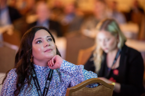 Kenna Pell is pictured watching a live downlink from the space station at the International Space Station Research & Development Conference in 2022. Credit: NASA