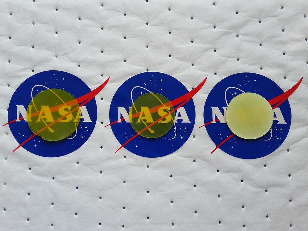 Transparency of silica based aerogels on top of NASA logo.