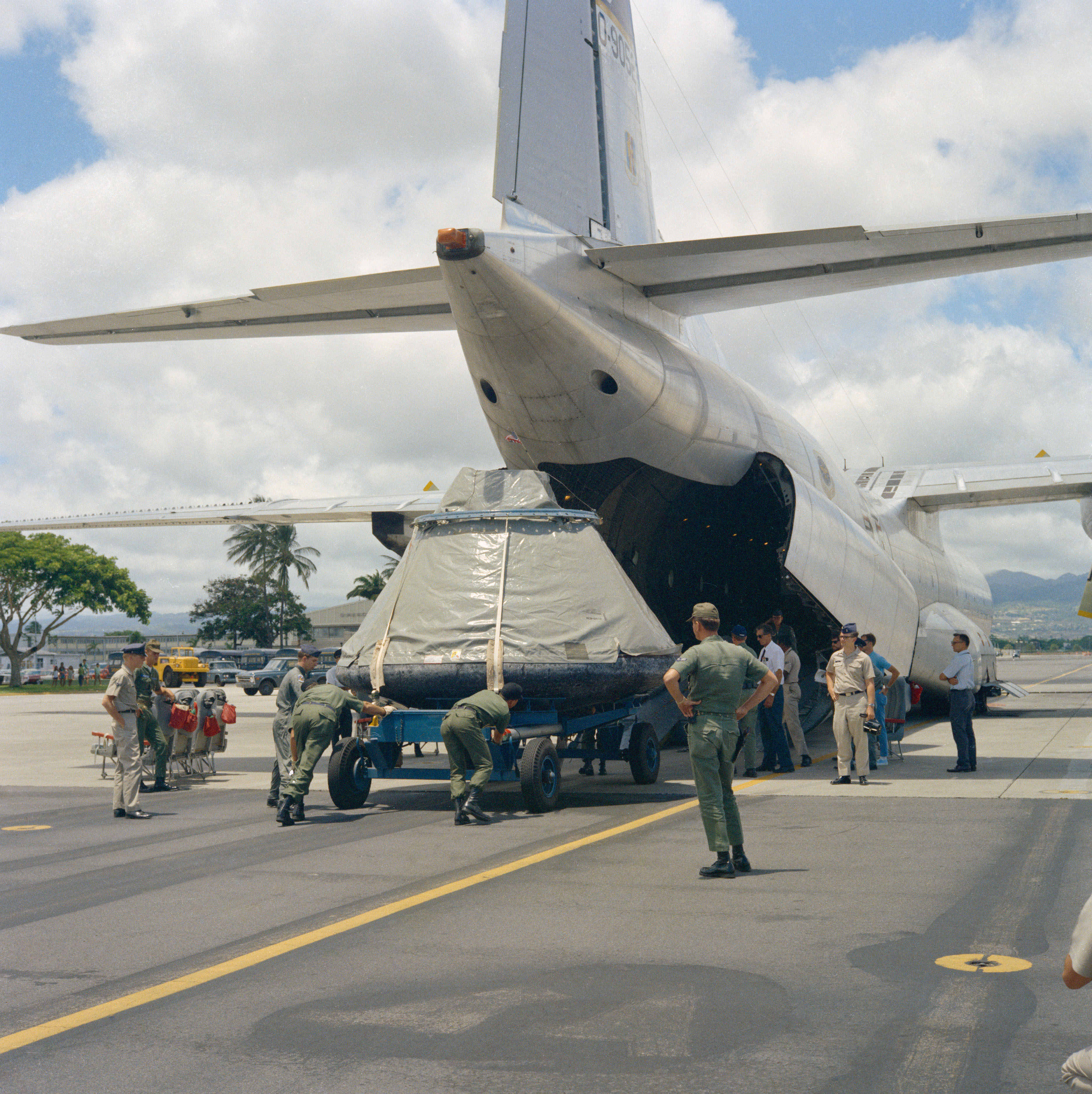 Airmen load Columbia onto a cargo plane at Hickam AFB for the flight to Houston