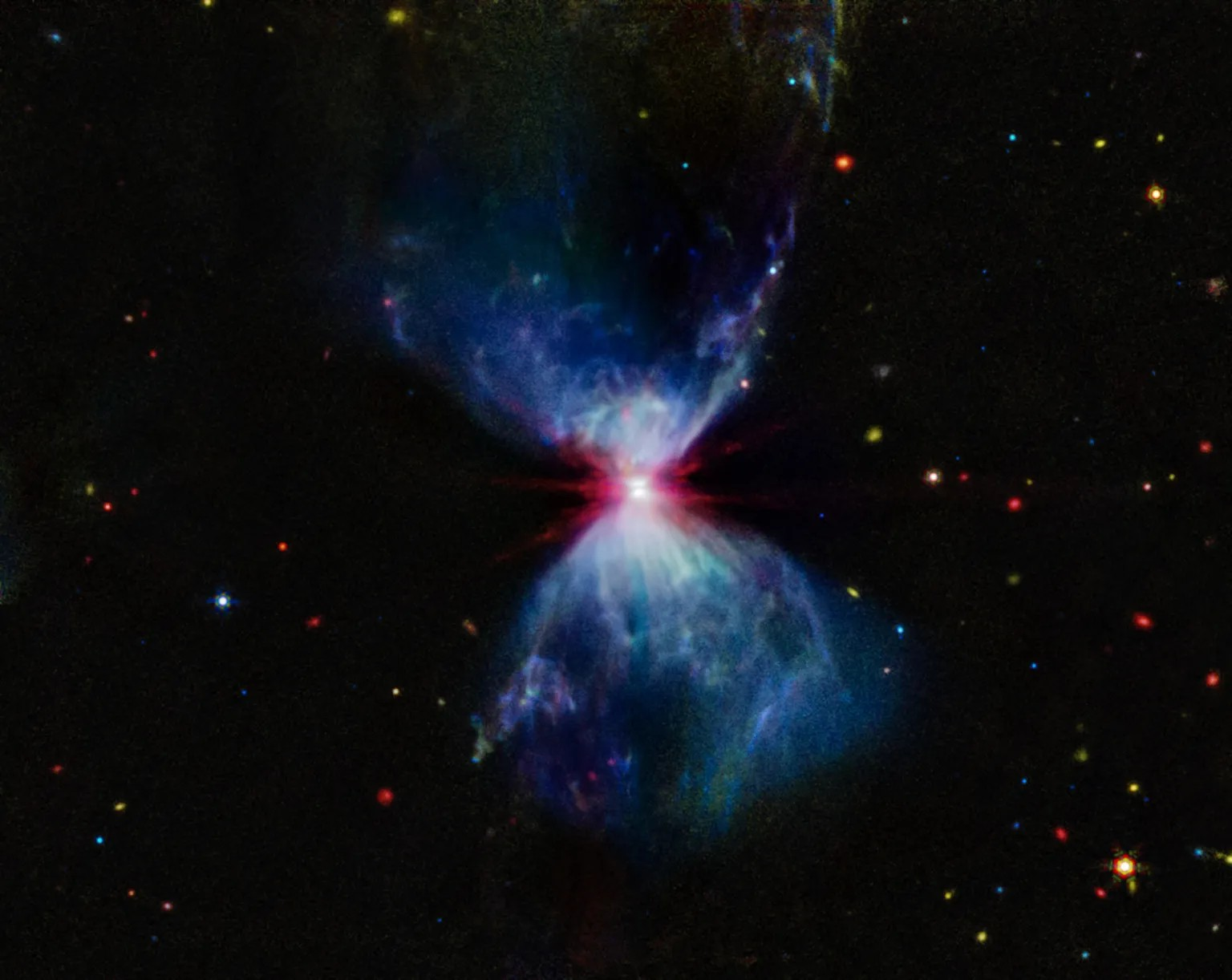 : L1527, shown in this image from NASA’s James Webb Space Telescope’s MIRI (Mid-Infrared Instrument), is a molecular cloud that harbors a protostar. It resides about 460 light-years from Earth in the constellation Taurus. The more diffuse blue light and the filamentary structures in the image come from organic compounds known as polycyclic aromatic hydrocarbons (PAHs), while the red at the center of this image is an energized, thick layer of gases and dust that surrounds the protostar. The region in between, which shows up in white, is a mixture of PAHs, ionized gas, and other molecules. This image includes filters representing 7.7 microns light as blue, 12.8 microns light as green, and 18 microns light as red.