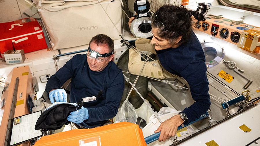 NASA astronauts Butch Wilmore and Suni Williams, Boeing's Crew Flight Test Commander and Pilot respectively, inspect safety hardware aboard the space station.