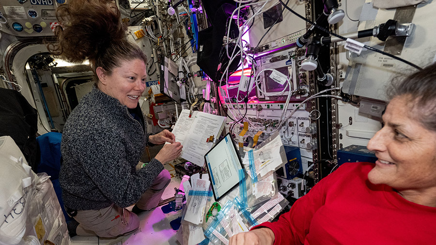 NASA astronauts (from left) Tracy C. Dyson and Suni Williams update emergency procedure manuals aboard the space station's Columbus laboratory module.
