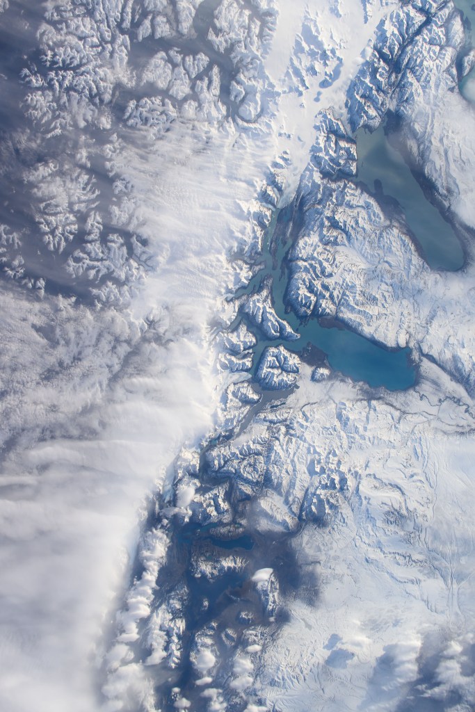 iss071e340347 (July 13, 2024) -- Rugged, snow-covered terrain surrounds Lakes Viedma and Argentino, a duo of Patagonian lakes in Argentina. As the International Space Station orbited 274 miles above, NASA astronaut Suni Williams captured this photo.