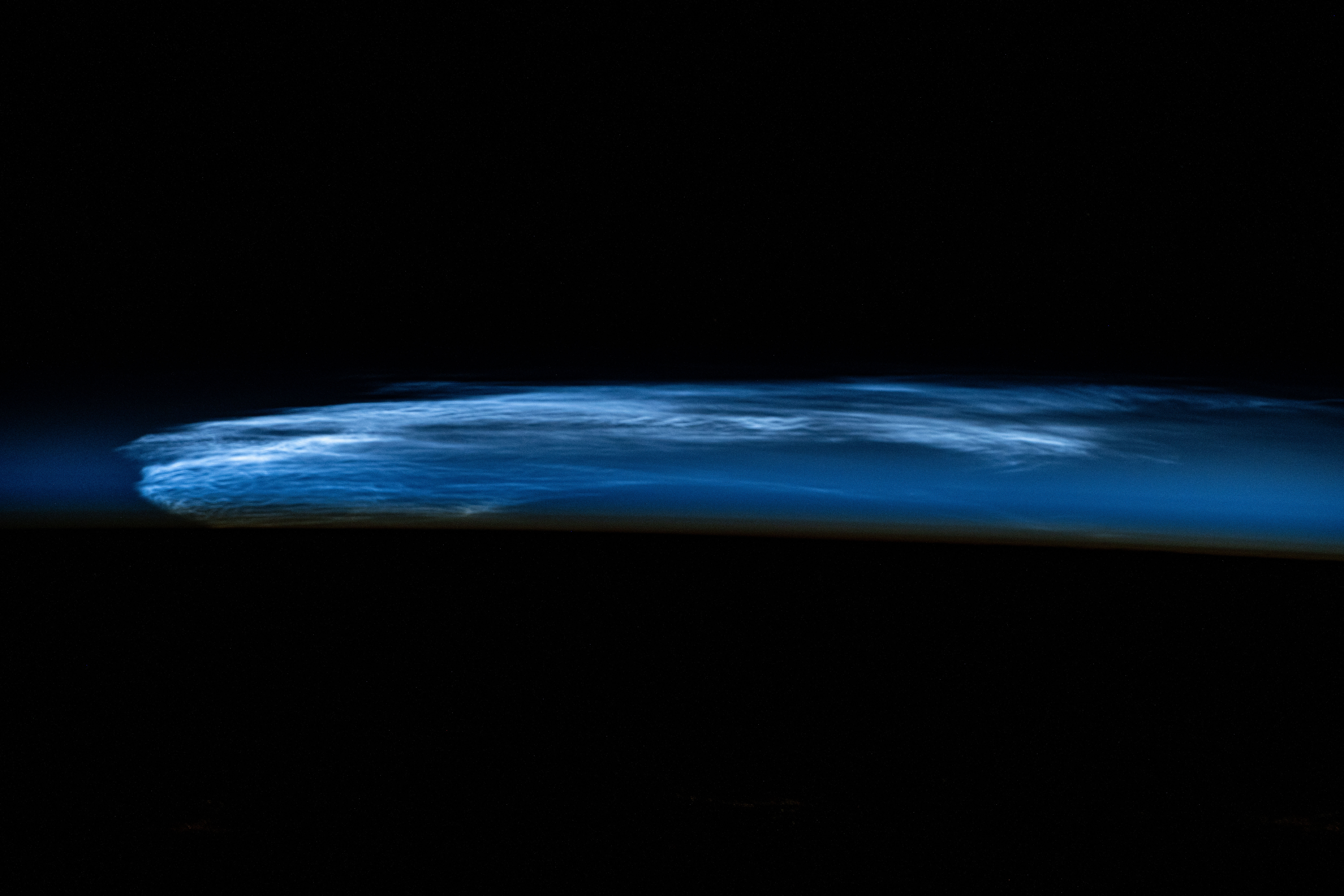Noctilucent clouds, high altitude clouds only visible when the Sun is below the Earth's horizon and illuminating them, are pictured from the International Space Station as it orbited 258 miles above eastern Turkey.