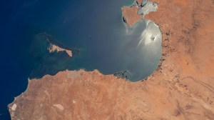 The sun's glint beams off the Gulf of Gabes on the coast of Tunisia with Sharqi Island in the Mediterranean Sea in this photograph taken from the International Space Station as it orbited 262 miles above the African nation.