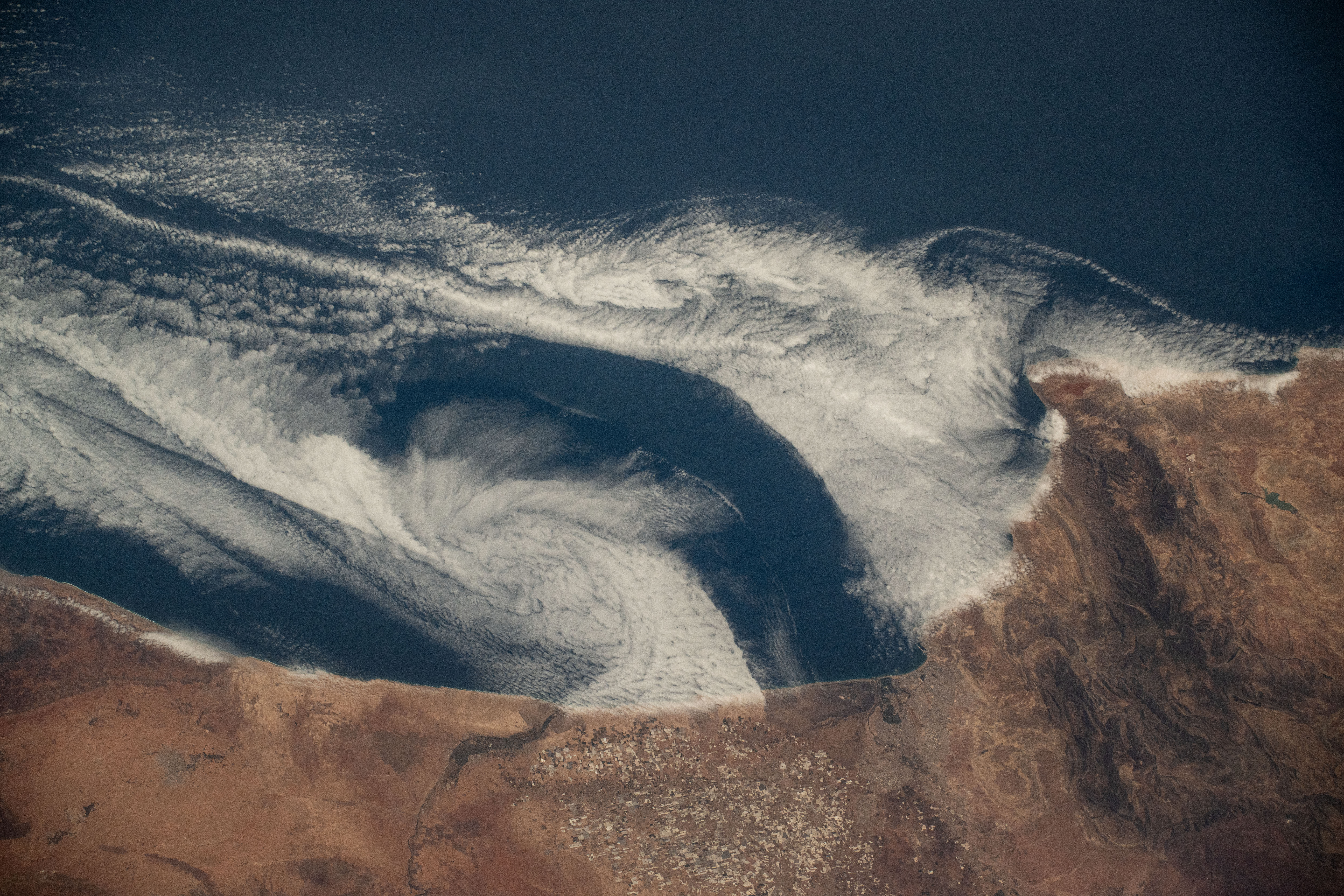 Clouds swirl into the coast of Morocco, hanging low over the Atlantic Ocean, as the International Space Station orbited 258 miles above.