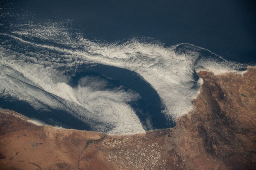 Clouds swirl into the coast of Morocco, hanging low over the Atlantic Ocean, as the International Space Station orbited 258 miles above.