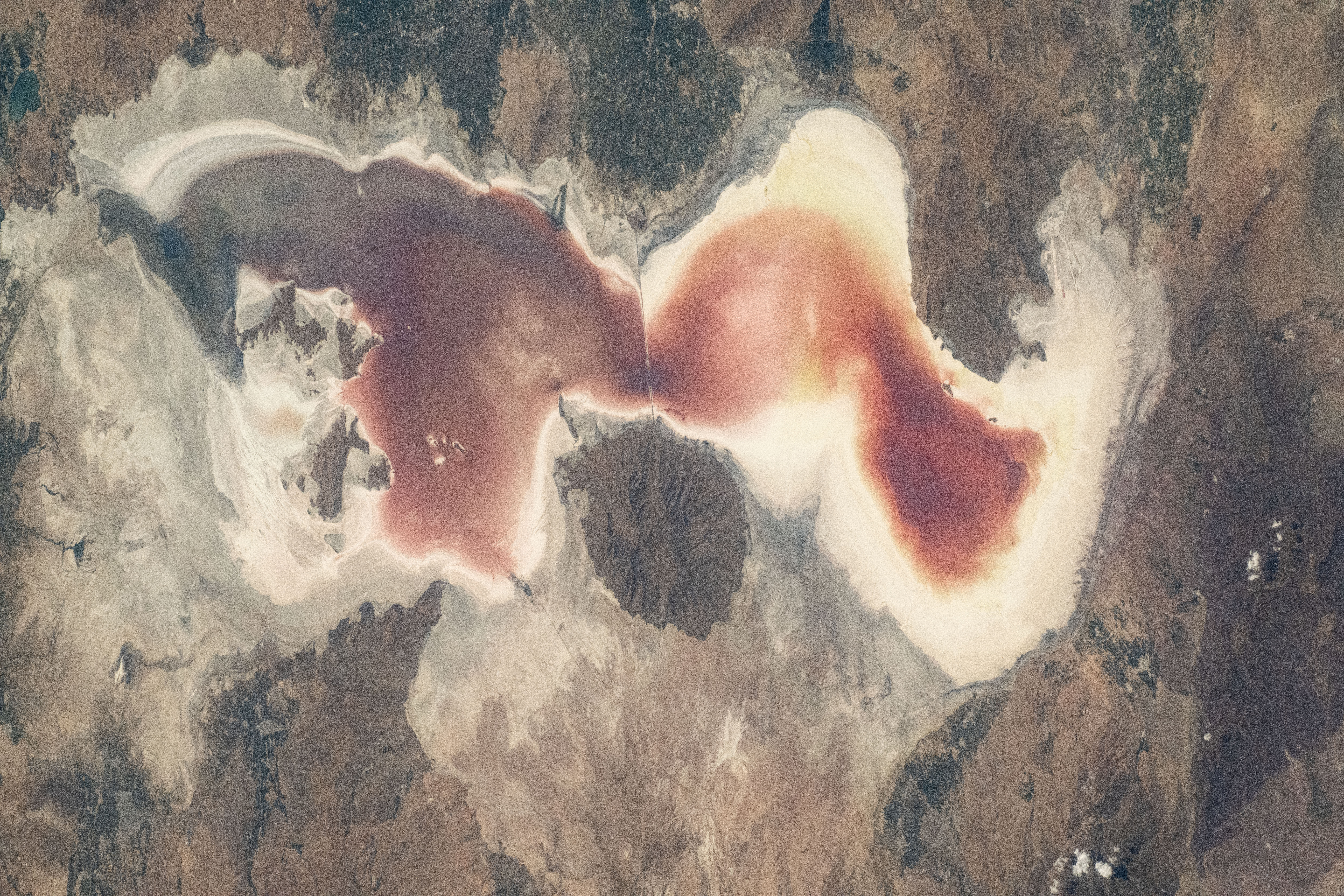 The rich red saltwater of Lake Urmia is pictured from the International Space Station as it orbited 260 miles above. Over the past few decades, the lake has shrunk, causing higher salt concentrations in the water, resulting in microscopic organisms turning the water shades of red and orange.