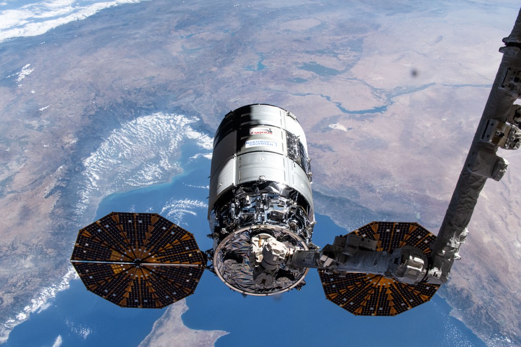 Northrop Grumman's Cygnus cargo craft, with its prominent cymbal-shaped UltraFlex solar arrays, is pictured in the grips of the Canadarm2 robotic arm shortly after its capture was commanded by Expedition 71 Flight Engineer Matthew Dominick of NASA. The maneuver marked the 50th free-flying capture for the Canadarm2 robotic arm. The International Space Station was orbiting 262 miles above the Mediterranean Sea at the time of this photograph.
