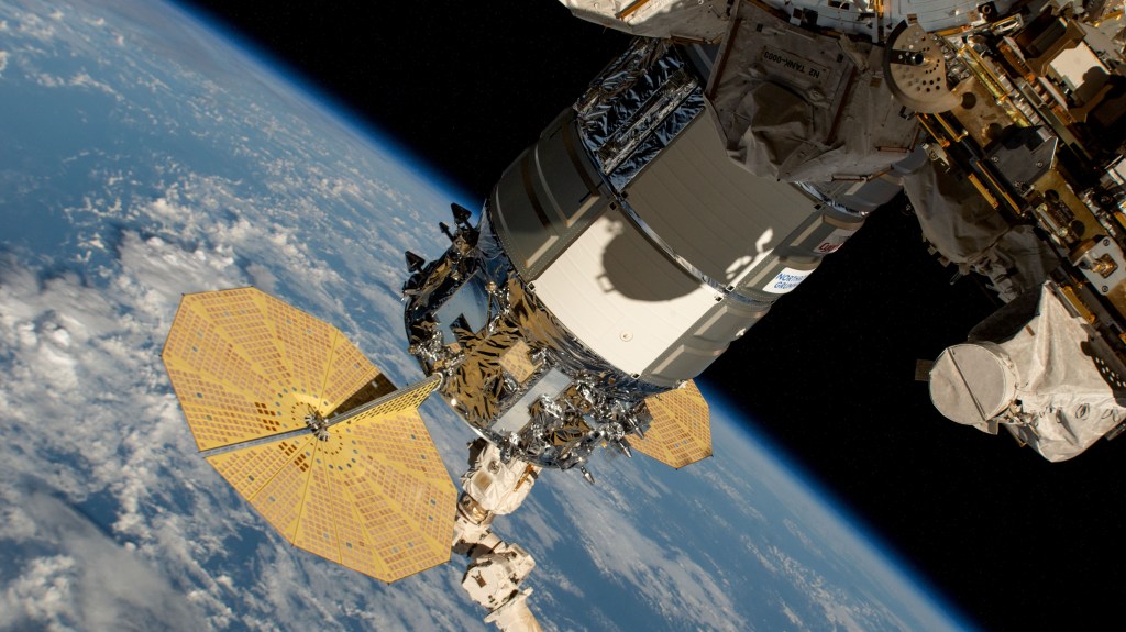 Still in the grips of the Canadarm2 robotic arm, the Northrop Grumman Cygnus space freighter is pictured attached to the Unity module's Earth-facing port. The International Space Station was orbiting 262 miles above a cloudy Pacific Ocean halfway between the U.S. island of Hawaii and the island nation of the Republic of Kiribati at the time of this photograph.